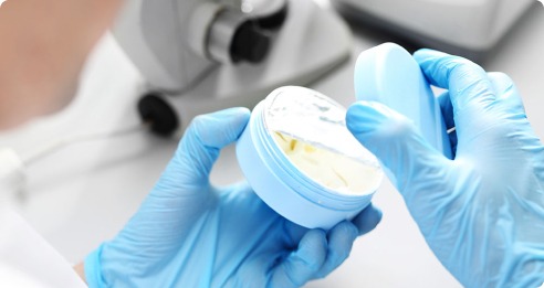 Hand with a cup of cream