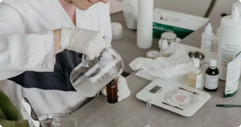 Scientist pouring in a bottle