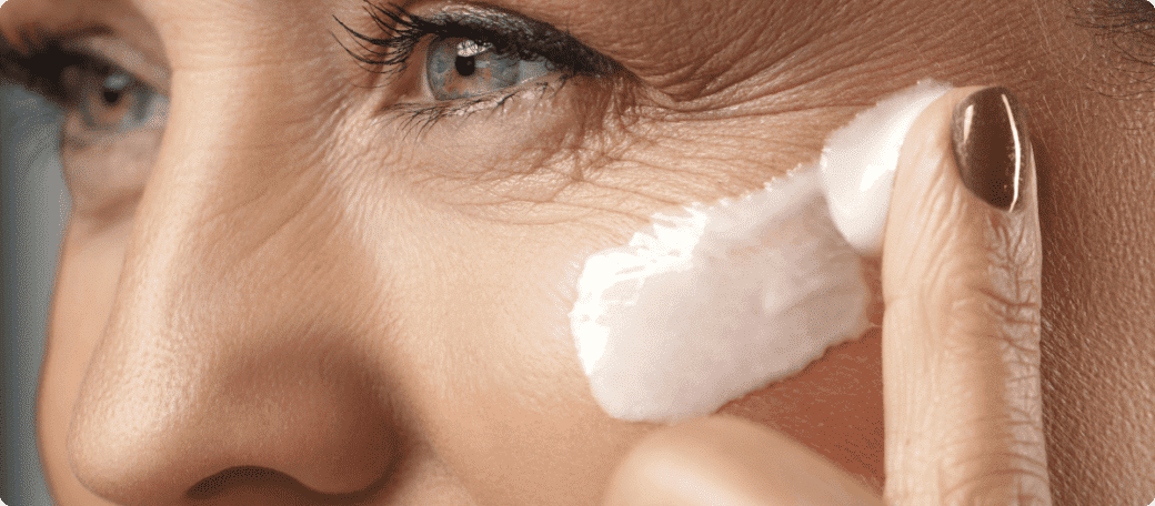 women applying cream in his face